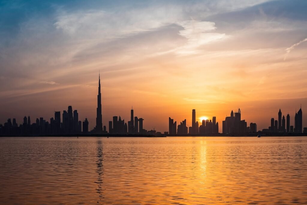 Dubai skyline and Burj Khalifa at sunset viewed across the waterfront – captured to represent Dubai’s luxury real estate lifestyle by Tohid Fetrat