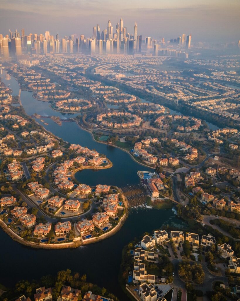 Aerial shot of Jumeirah Islands community, showing villas arranged around turquoise artificial lakes.