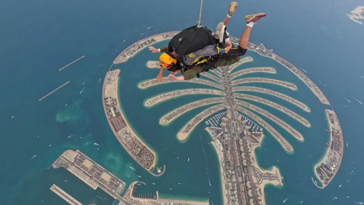 Skydiving over Palm Jumeirah Dubai — breathtaking aerial view of the palm-shaped island and turquoise waters — captured from above and presented by Tohid Fetrat.