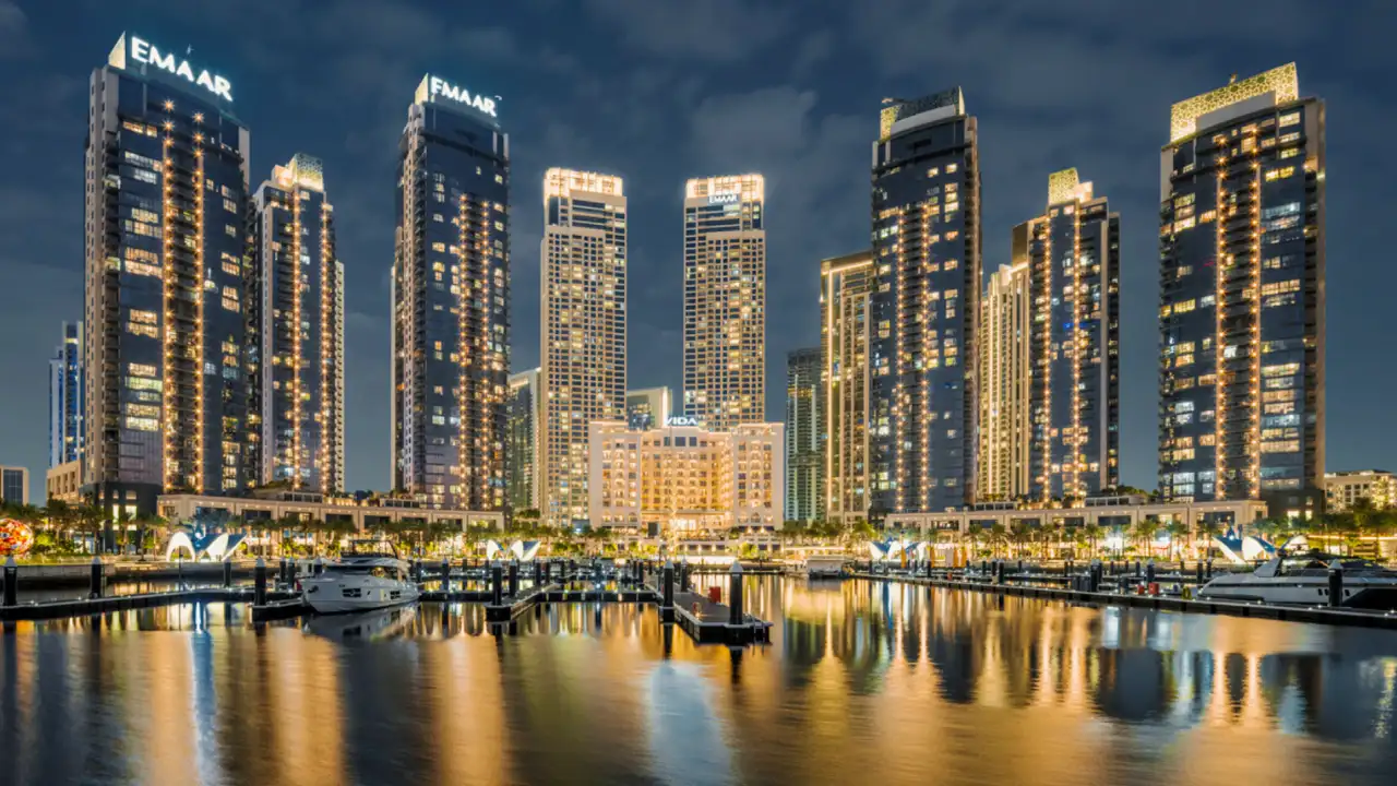 Dubai Creek Harbour waterfront skyline with Emaar towers and marina view at night — presented by Tohid Fetrat.