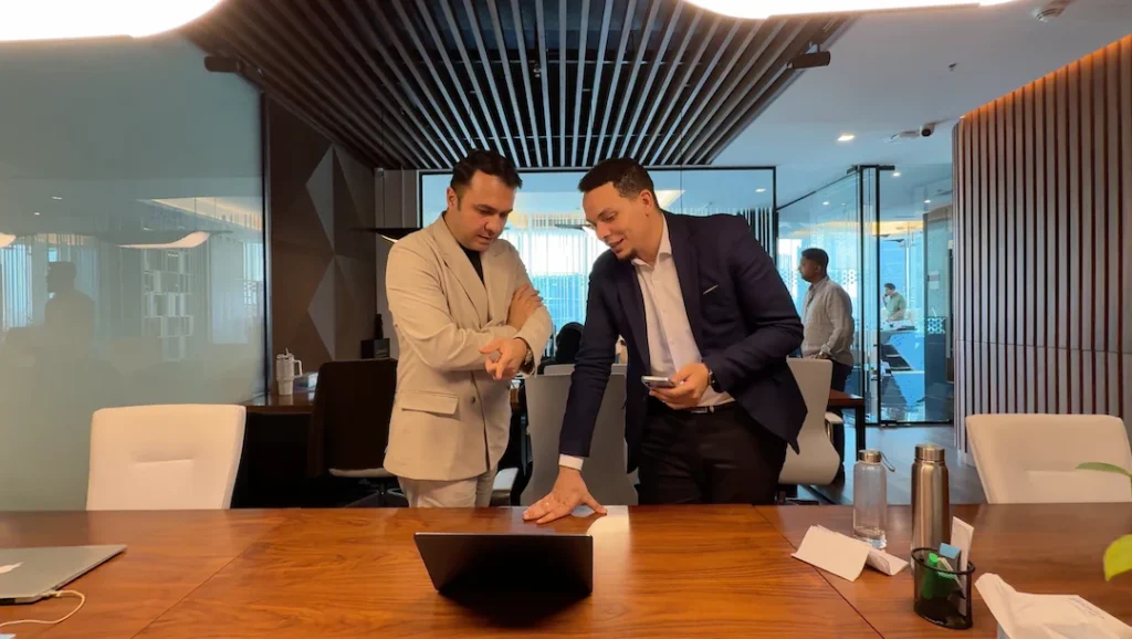 Tohid Fetrat advising an international investor on Dubai off-plan property opportunities during a real estate consultation meeting.