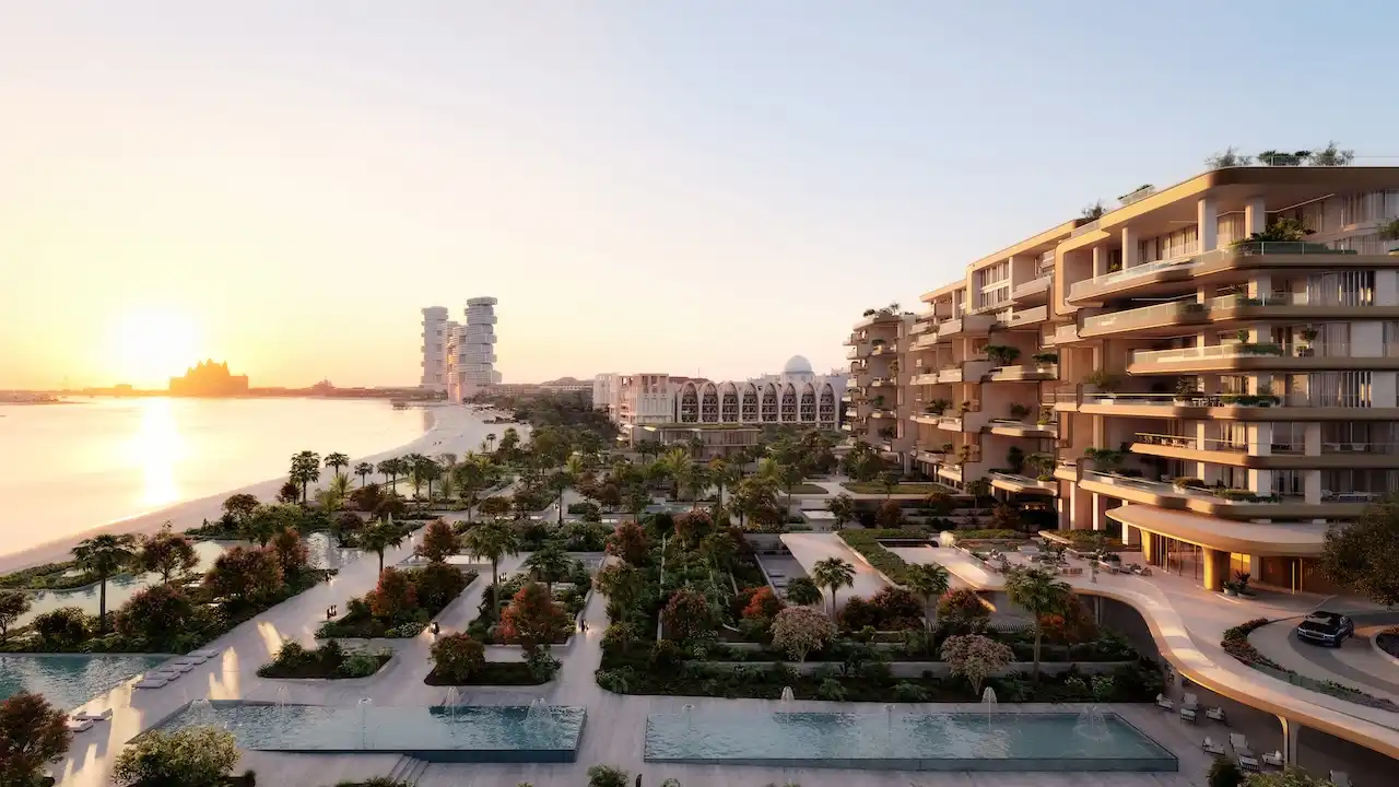 Sunset view of the Central Oasis at Alba Residences, Dorchester Collection by OMNIYAT, on Palm Jumeirah, featuring terraced architecture, lush landscaped gardens, water features, and direct beachfront views overlooking the Gulf. Presented by Tohid Fetrat.