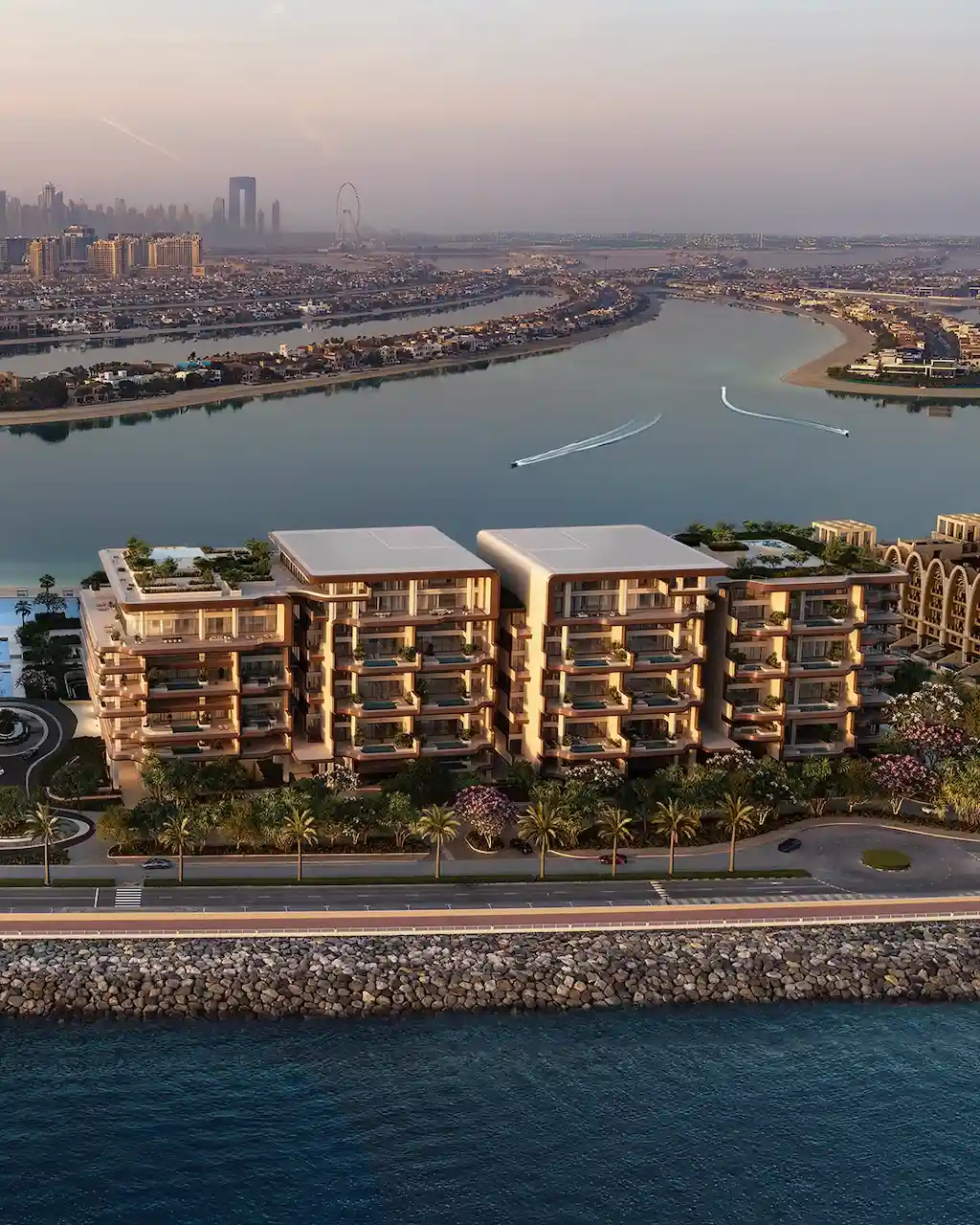 Aerial waterfront view of Alba Residences, Dorchester Collection by OMNIYAT, on Palm Jumeirah, overlooking tranquil lagoon waters, landscaped surroundings, and low rise beachfront architecture with panoramic views of the Gulf. Presented by Tohid Fetrat.