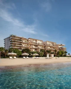 Beachfront view of Alba Residences, Dorchester Collection by OMNIYAT, on Palm Jumeirah overlooking the Gulf, featuring refined low-rise architecture and private shoreline living. Presented by Tohid Fetrat.