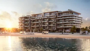 Sunrise beachfront view of Alba Residences, Dorchester Collection by OMNIYAT on Palm Jumeirah, featuring low rise contemporary architecture, private beach access, landscaped gardens, and calm waterfront living. Presented by Tohid Fetrat.