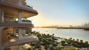 Waterfront balcony view at Alba Residences, Dorchester Collection by OMNIYAT on Palm Jumeirah, showcasing layered contemporary architecture, landscaped beachfront gardens, and panoramic skyline views across the Gulf. Presented by Tohid Fetrat.