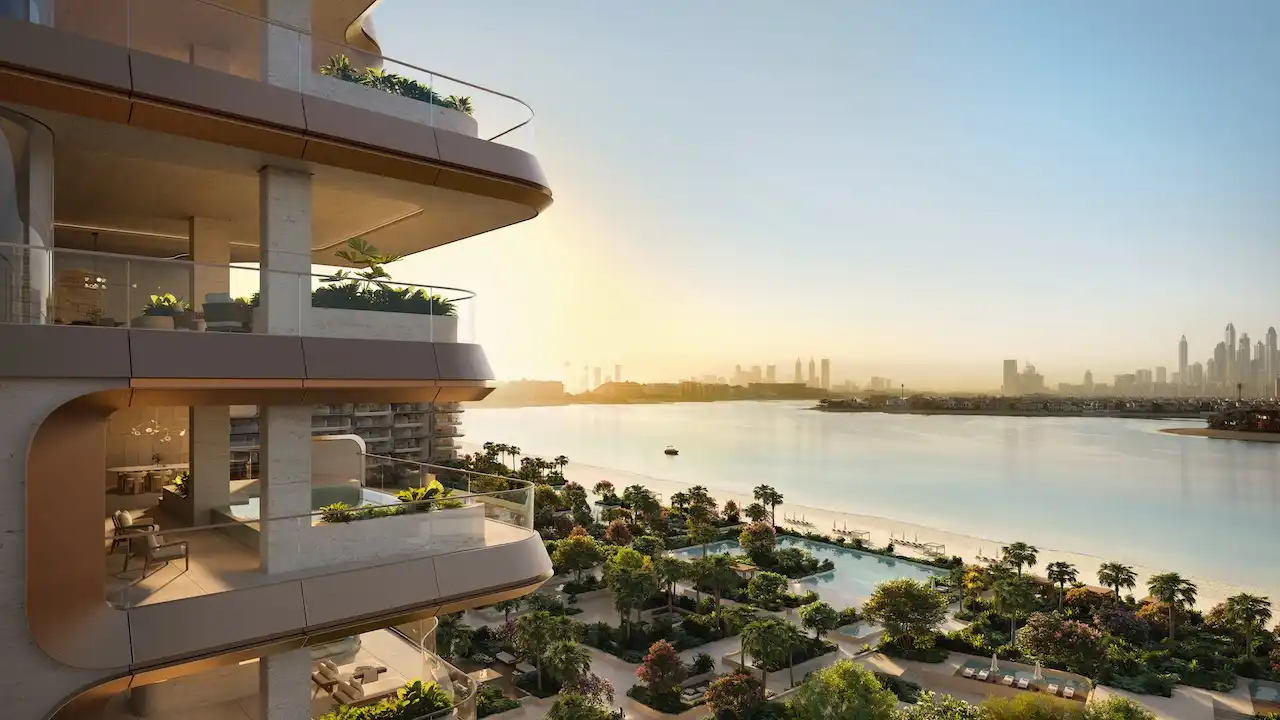 Waterfront balcony view at Alba Residences, Dorchester Collection by OMNIYAT on Palm Jumeirah, showcasing layered contemporary architecture, landscaped beachfront gardens, and panoramic skyline views across the Gulf. Presented by Tohid Fetrat.