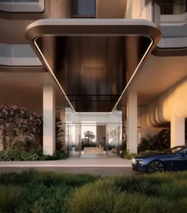 Grand arrival entrance of Alba Residences, Dorchester Collection by OMNIYAT on Palm Jumeirah, featuring sculptural architectural canopy, luxury drop off area, landscaped surroundings, and refined beachfront living. Presented by Tohid Fetrat.
