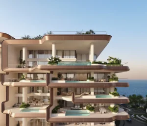 Luxury facade of Alba Residences, Dorchester Collection by OMNIYAT on Palm Jumeirah, showcasing expansive private terraces, infinity pools, and contemporary beachfront architecture. Presented by Tohid Fetrat.