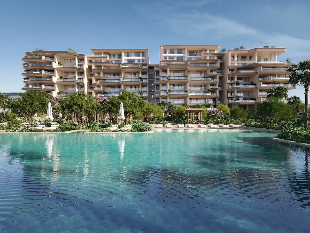 Luxury swimming pool surrounded by landscaped gardens at Alba Residences, Dorchester Collection by OMNIYAT on Palm Jumeirah, featuring contemporary beachfront architecture. Presented by Tohid Fetrat.