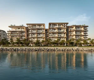 Roadside waterfront view of Alba Residences, Dorchester Collection by OMNIYAT on Palm Jumeirah, showcasing contemporary low rise architecture, landscaped frontage, and serene coastal surroundings. Presented by Tohid Fetrat.
