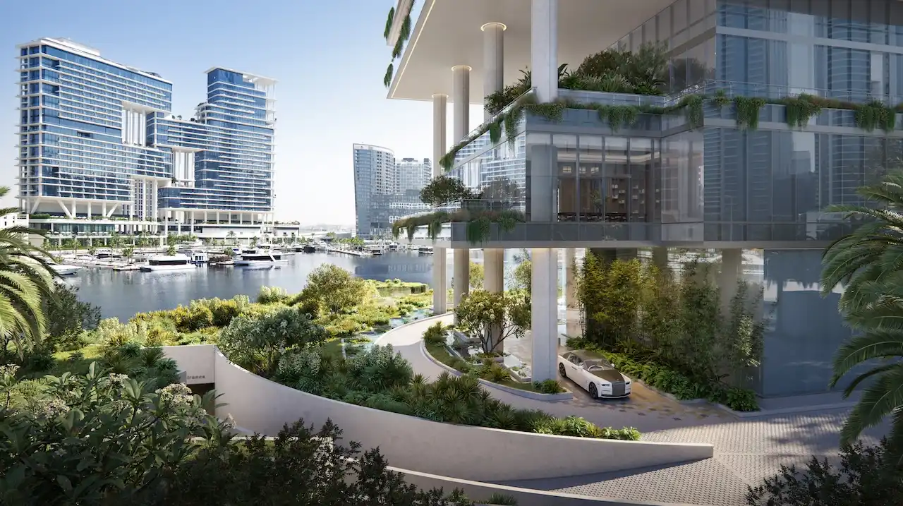 Arrival drop-off view of ENARA by OMNIYAT in Marasi Bay, Business Bay, featuring a landscaped waterfront entrance with marina views and contemporary office architecture. Presented by Tohid Fetrat.
