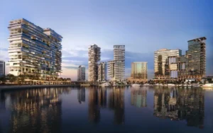 Waterfront skyline view of ENARA by OMNIYAT in Marasi Bay, Business Bay, featuring contemporary commercial towers reflected across the marina waterfront. Presented by Tohid Fetrat.