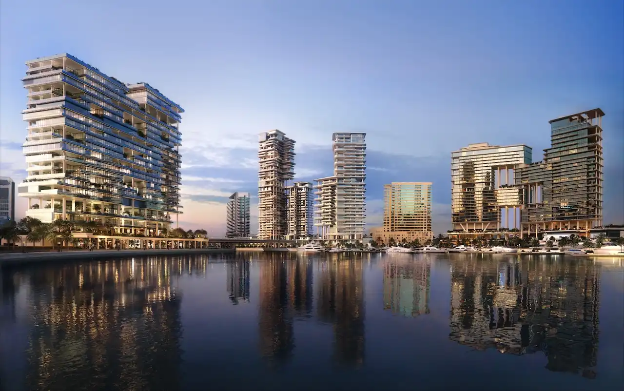 Waterfront skyline view of ENARA by OMNIYAT in Marasi Bay, Business Bay, featuring contemporary commercial towers reflected across the marina waterfront. Presented by Tohid Fetrat.