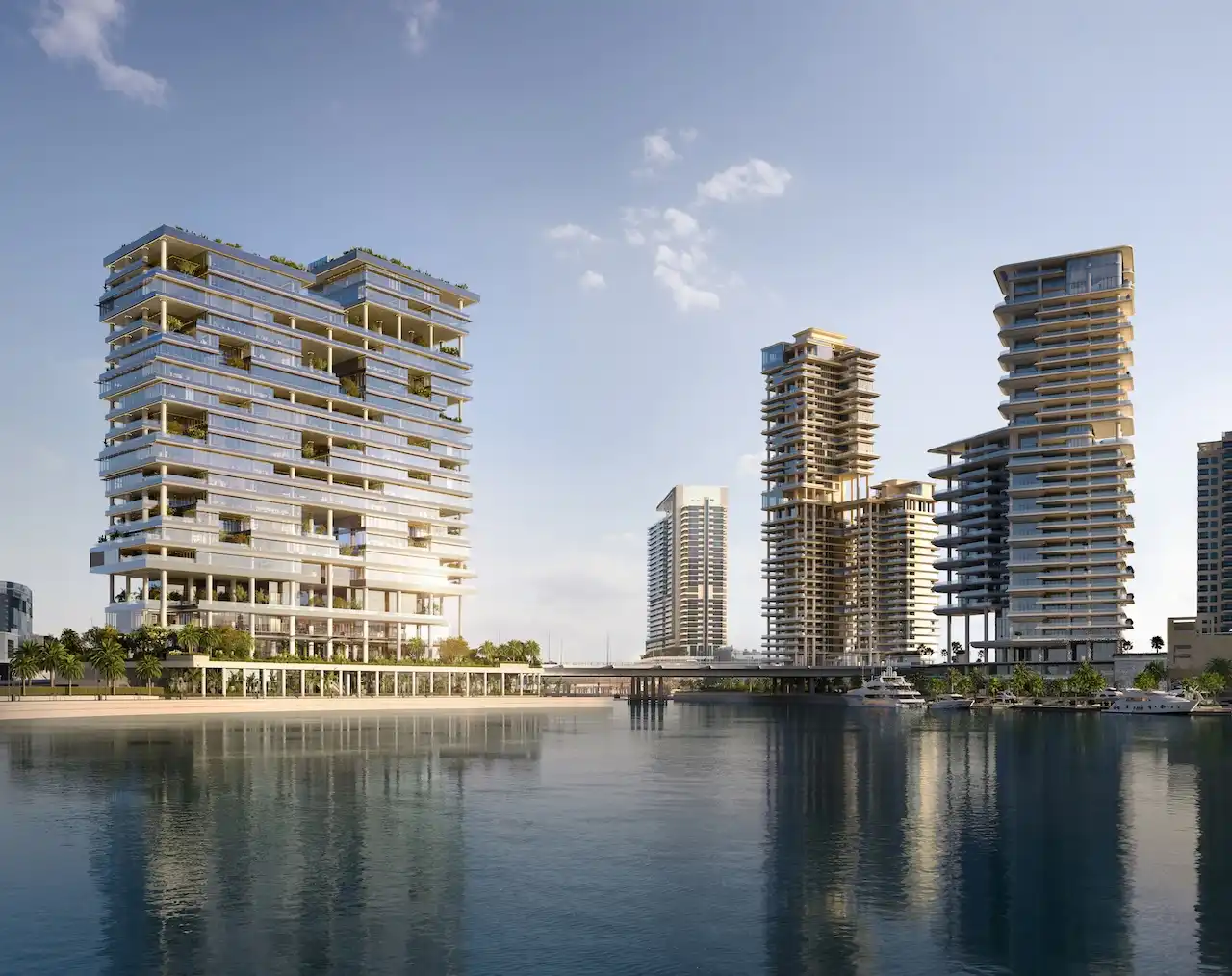 Waterfront view of ENARA by OMNIYAT in Marasi Bay, Business Bay, featuring contemporary commercial towers rising along the marina and reflecting across the calm waterfront. Presented by Tohid Fetrat.