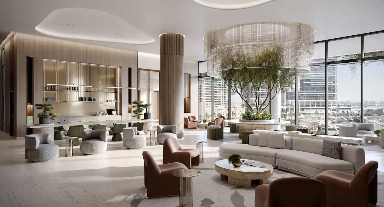 Members club pre function lounge interior at ENARA by OMNIYAT featuring contemporary seating areas, a refined café bar, sculptural ceiling forms, integrated indoor trees, and floor to ceiling glazing with Business Bay city views in Dubai. Presented by Tohid Fetrat.