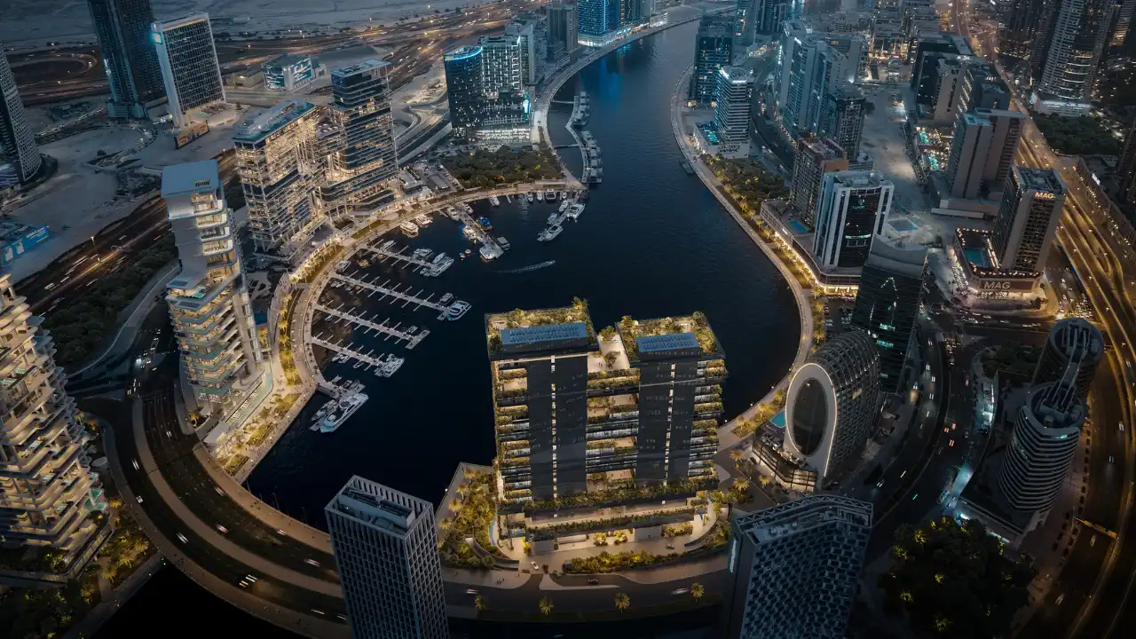 Night aerial masterplan view of ENARA by OMNIYAT in Marasi Bay, Business Bay, highlighting the waterfront commercial district, Dubai Canal, surrounding towers, and marina connectivity. Presented by Tohid Fetrat.