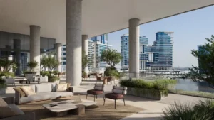 Second unique view of the elevated skydeck terrace at ENARA by OMNIYAT in Business Bay, featuring canal-facing outdoor seating, architectural columns, landscaped planters, and modern commercial design. Presented by Tohid Fetrat.
