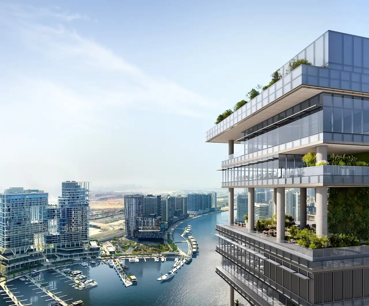 High-level terrace view at ENARA by OMNIYAT in Business Bay, overlooking the Dubai Canal and surrounding skyline, featuring cantilevered architecture, glass façades, and elevated outdoor spaces. Presented by Tohid Fetrat.