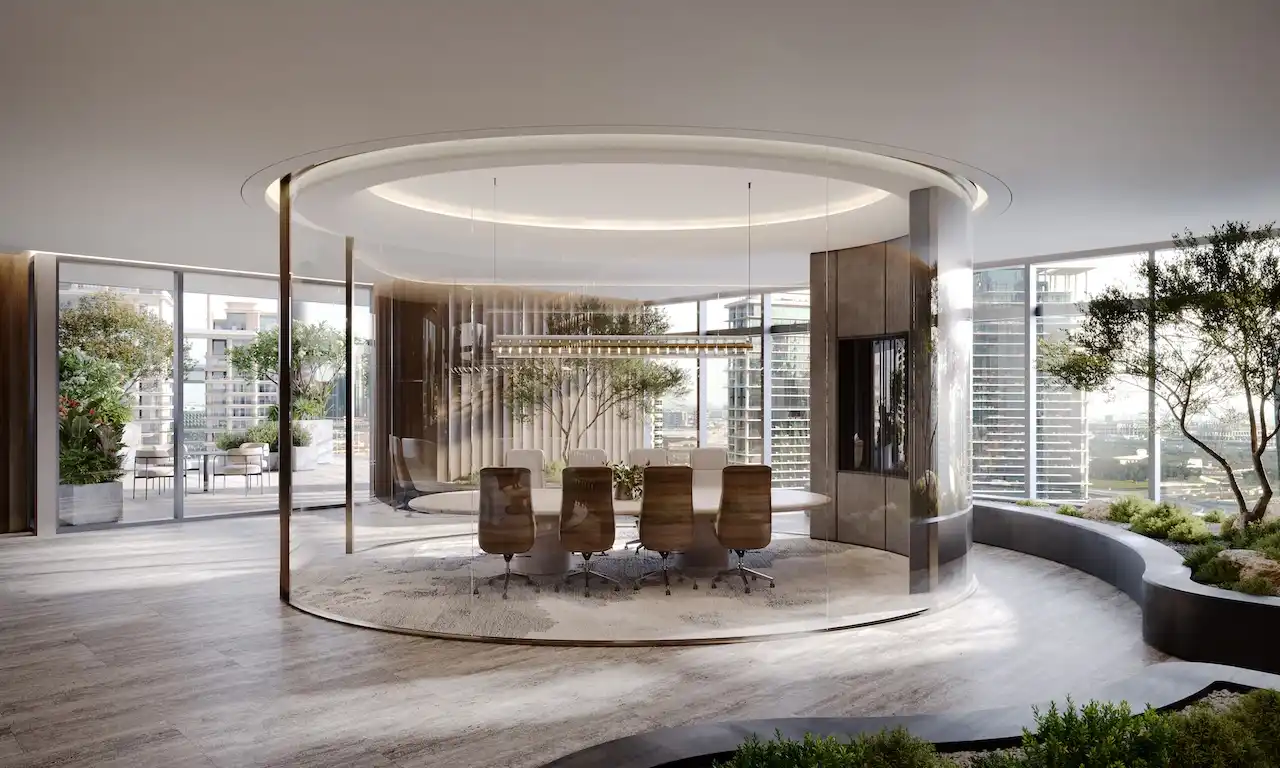Triplex boardroom interior at ENARA by OMNIYAT featuring a circular glass enclosed meeting room, executive seating, sculptural ceiling lighting, integrated greenery, and floor to ceiling windows with Business Bay city views in Dubai. Presented by Tohid Fetrat.