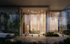 VIP drop off entrance at ENARA by OMNIYAT in Business Bay, featuring a double height glass lobby, luxury vehicle access, refined lighting design, and contemporary commercial architecture. Presented by Tohid Fetrat.