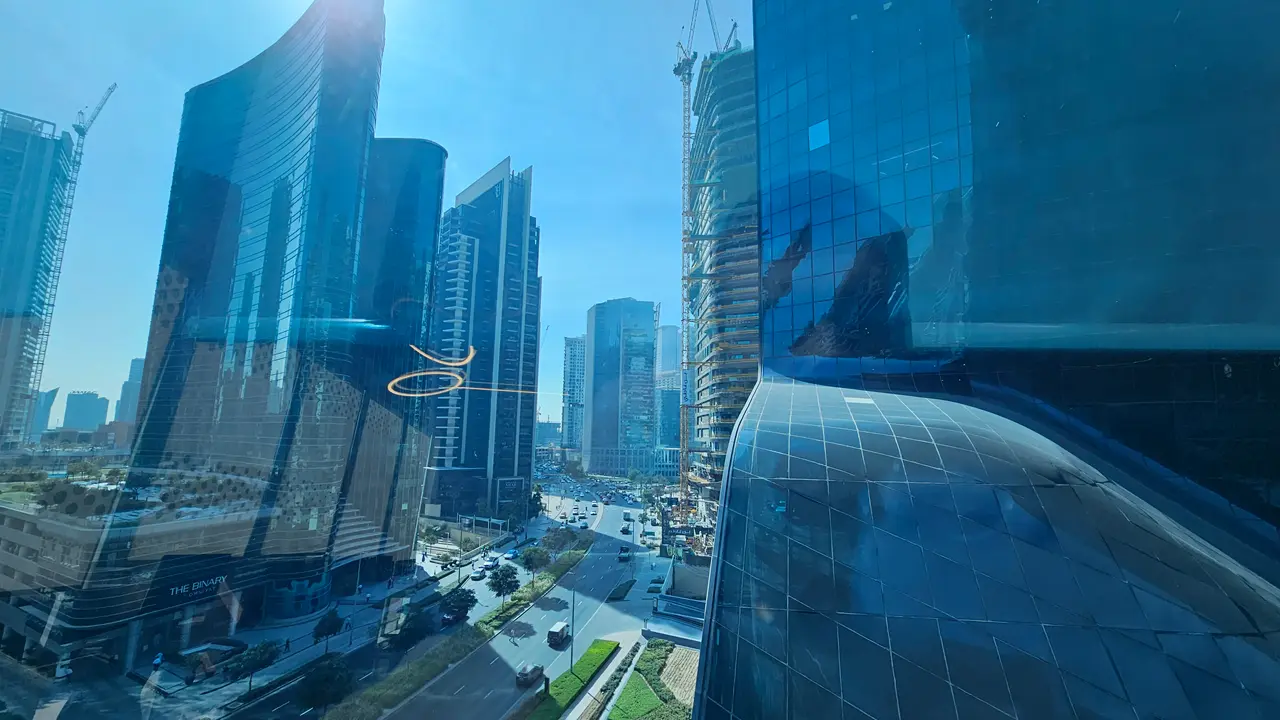 Business Bay skyline view featuring Opus Tower Bugatti Residences by Binghatti The Binary by Omniyat and Ahad Tower with modern high rise architecture and urban city streets captured by Tohid Fetrat.