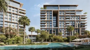 City Walk Crestlane by Meraas showing luxury modern residences overlooking a lagoon style pool with sun loungers palm trees and landscaped greenery presented by Tohid Fetrat.