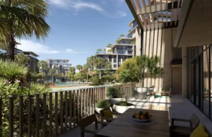 City Walk Crestlane by Meraas showing a luxury terrace deck with outdoor seating landscaped greenery and views of modern residences and the poolside community presented by Tohid Fetrat.