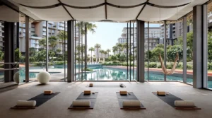 City Walk Crestlane by Meraas showing a luxury yoga and wellness studio with floor to ceiling windows relaxation mats natural light and serene views of the lagoon pool and residences presented by Tohid Fetrat.