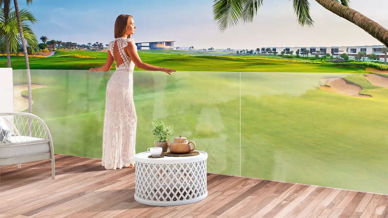 DAMAC Hills golf community in Dubai — elegant woman enjoying golf course view from balcony — luxury lifestyle by Tohid Fetrat.