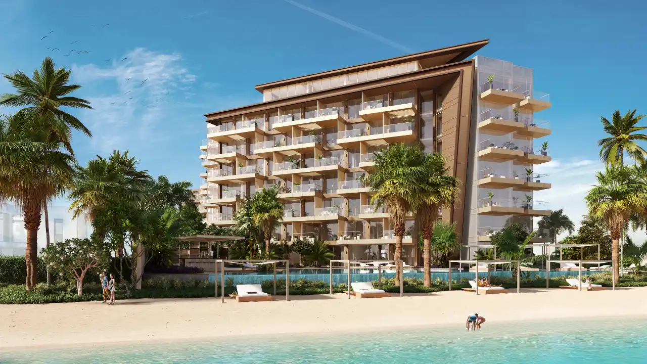 Beachfront view of Ellington Beach House featuring modern low-rise architecture, private beach access, palm-lined landscaping, and luxury residences by the water in Dubai. Presented by Tohid Fetrat.