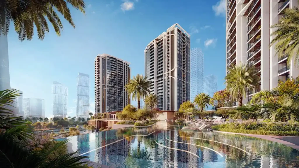 Exterior view of Eltiera Views featuring landscaped gardens, resort-style swimming pool, and modern residential towers in Dubai. Presented by Tohid Fetrat.