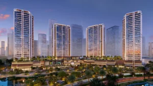 Night hero view of Eltiera Views featuring four illuminated residential towers above a landscaped podium and waterfront setting in Dubai. Presented by Tohid Fetrat.