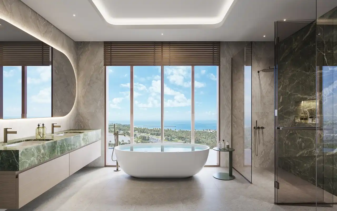Hado duplex master bathroom with freestanding bathtub panoramic sea view green marble double vanity and modern walk in shower in the SIORA community by Beyond presented by Tohid Fetrat.