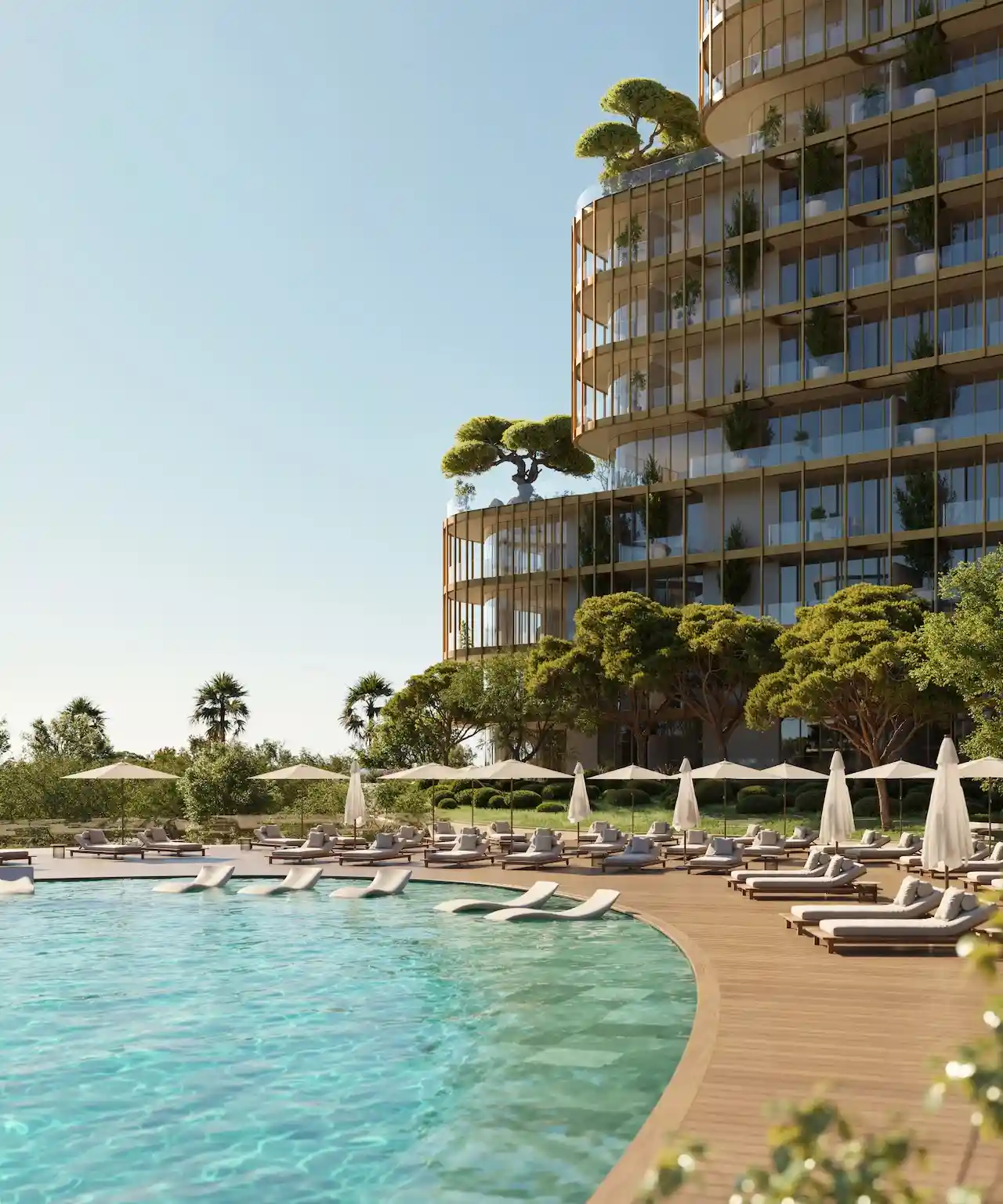 Pool deck at Hado in the SIORA community by Beyond featuring sun loungers an infinity style pool lush landscaping and the stepped architectural design of the tower presented by Tohid Fetrat.