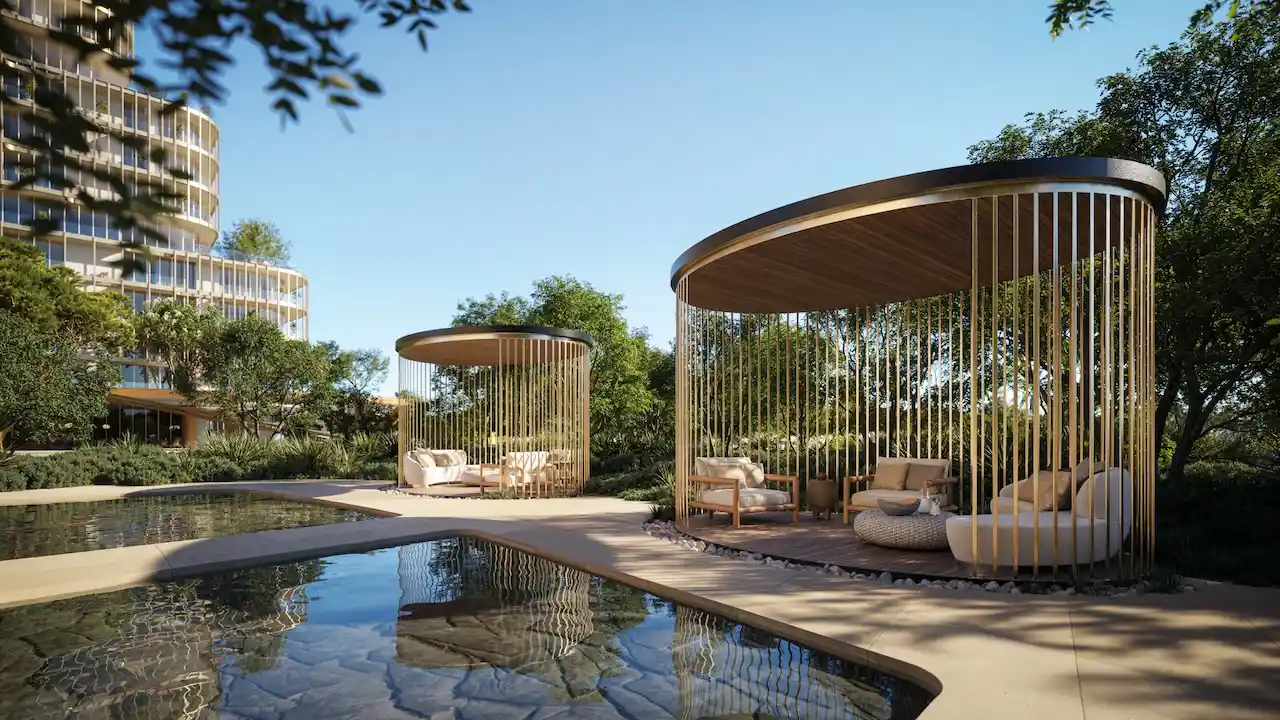 Luxury garden cabanas at Hado Tower in the SIORA community by Beyond featuring circular shaded lounge areas surrounded by greenery and reflective water presented by Tohid Fetrat.
