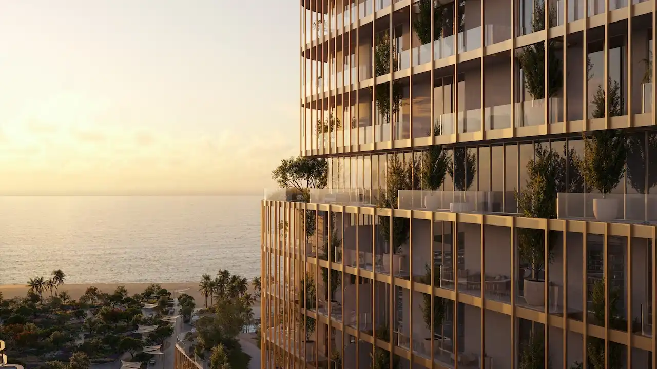 Sunset sea view of Hado Tower in the SIORA community by Beyond showing golden facade terraces with greenery overlooking the Gulf presented by Tohid Fetrat.