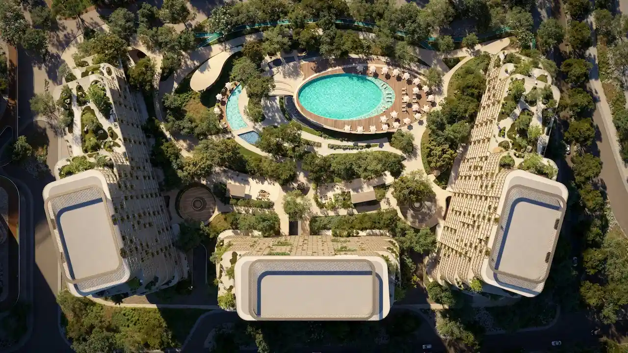 Aerial masterplan view of Hado Tower in the SIORA community by Beyond showing curved buildings lush landscaping and the central resort style pool presented by Tohid Fetrat.
