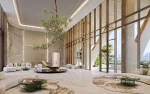 Luxurious lobby lounge at Hado Tower in the SIORA community by Beyond with double height windows sculptural centerpiece natural stone finishes and serene garden views presented by Tohid Fetrat.