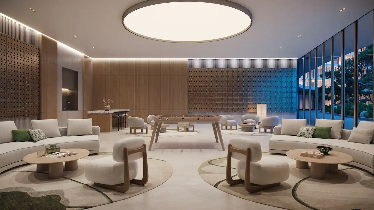 Multipurpose hall at Hado Tower in the SIORA community by Beyond featuring modern lounge seating warm wood paneling a foosball table and large glass windows overlooking landscaped gardens presented by Tohid Fetrat.