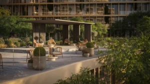 Outdoor social lounge terrace at Hado Tower in the SIORA community by Beyond featuring modern shaded seating lush landscaped greenery and warm architectural detailing presented by Tohid Fetrat.
