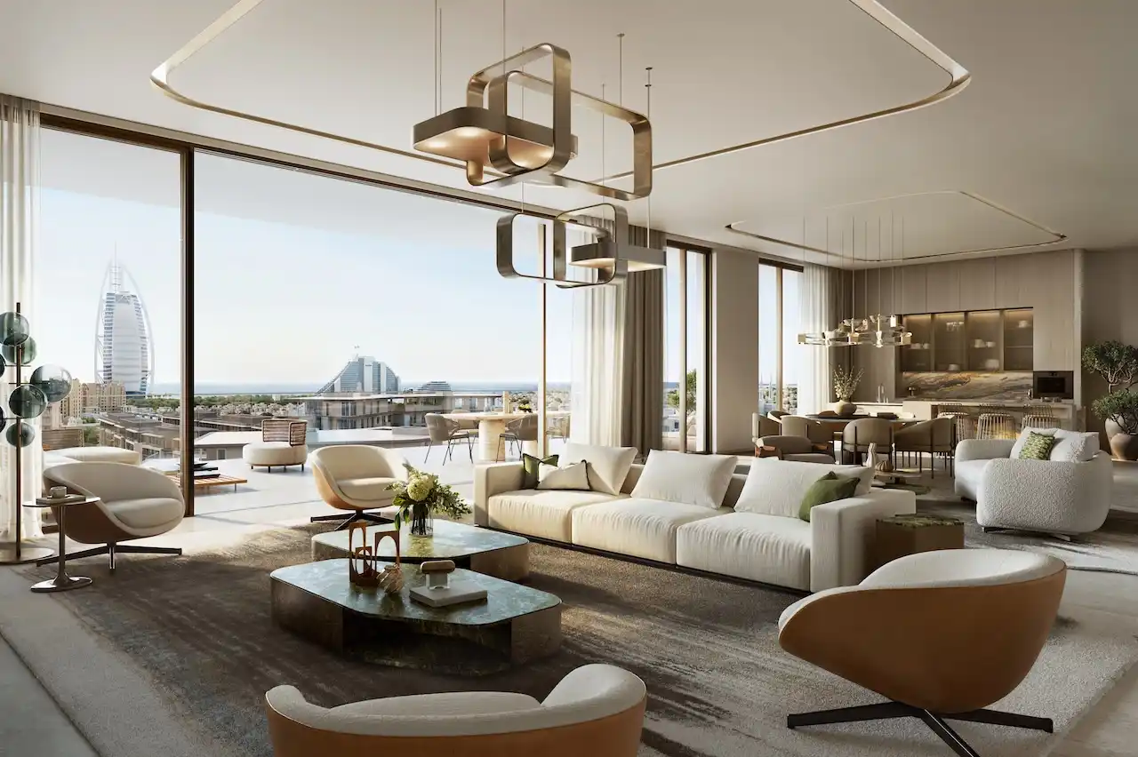 Luxury living and dining interior in a 4 bedroom apartment at MJL Nourelle in Madinat Jumeirah Living Dubai, showcasing open plan design, designer lighting, floor to ceiling windows and Burj Al Arab views. Presented by Tohid Fetrat.