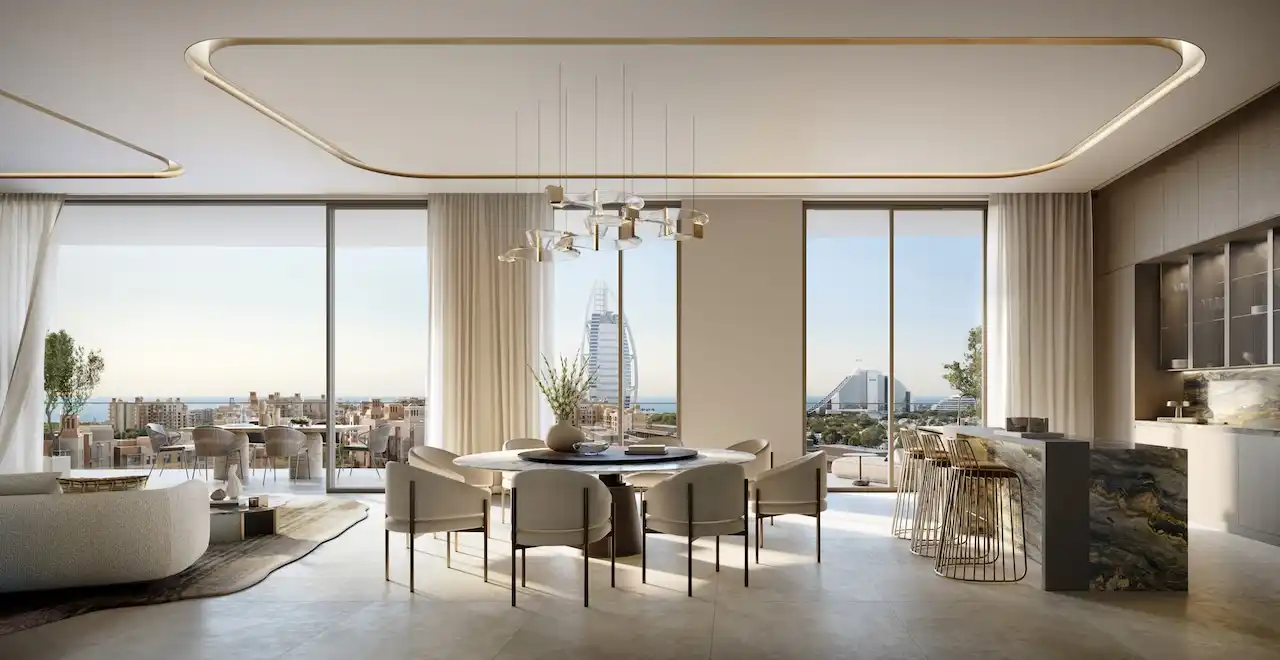 Elegant living and dining interior in a 4 bedroom apartment at MJL Nourelle in Madinat Jumeirah Living Dubai, featuring floor to ceiling windows, open plan layout, refined lighting design and panoramic city views. Presented by Tohid Fetrat.