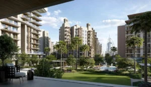 Community garden view of MJL Nourelle at Madinat Jumeirah Living Dubai, featuring low-rise residential buildings, landscaped green spaces, palm-lined walkways and a serene lifestyle setting near Burj Al Arab and the Gulf. Presented by Tohid Fetrat.