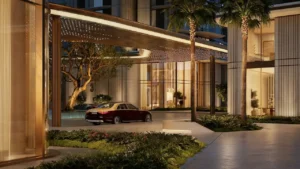 Drop off entrance view of MJL Nourelle in Madinat Jumeirah Living Dubai, featuring a covered porte cochere, refined contemporary architecture, landscaped arrival area and luxury residential ambiance near the Gulf. Presented by Tohid Fetrat.
