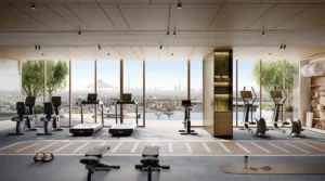 Modern fitness center at MJL Nourelle in Madinat Jumeirah Living Dubai, featuring state of the art gym equipment, floor to ceiling windows, city skyline views and a premium wellness environment. Presented by Tohid Fetrat.