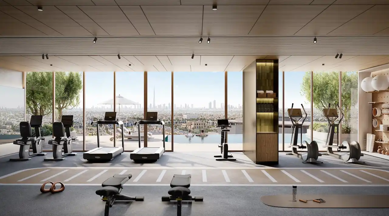 Modern fitness center at MJL Nourelle in Madinat Jumeirah Living Dubai, featuring state of the art gym equipment, floor to ceiling windows, city skyline views and a premium wellness environment. Presented by Tohid Fetrat.