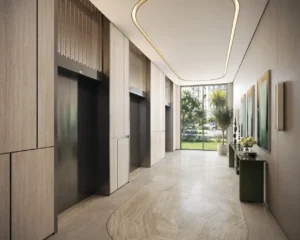 Elegant lobby and elevator area at MJL Nourelle in Madinat Jumeirah Living Dubai, featuring refined interior design, natural materials, soft lighting and a calm residential atmosphere. Presented by Tohid Fetrat.