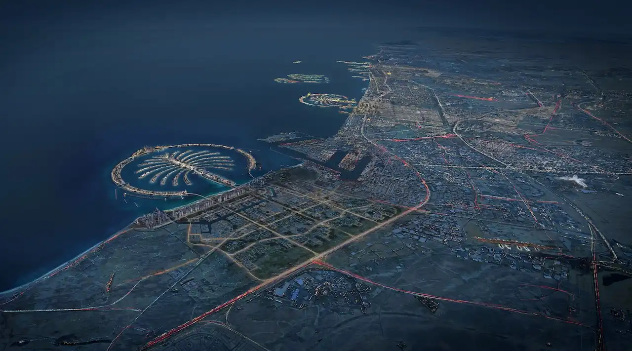 Wide aerial night view of Palm Jebel Ali showing the palm-shaped island, surrounding coastline, road networks, and urban layout of Dubai along the Gulf. Presented by Tohid Fetrat.