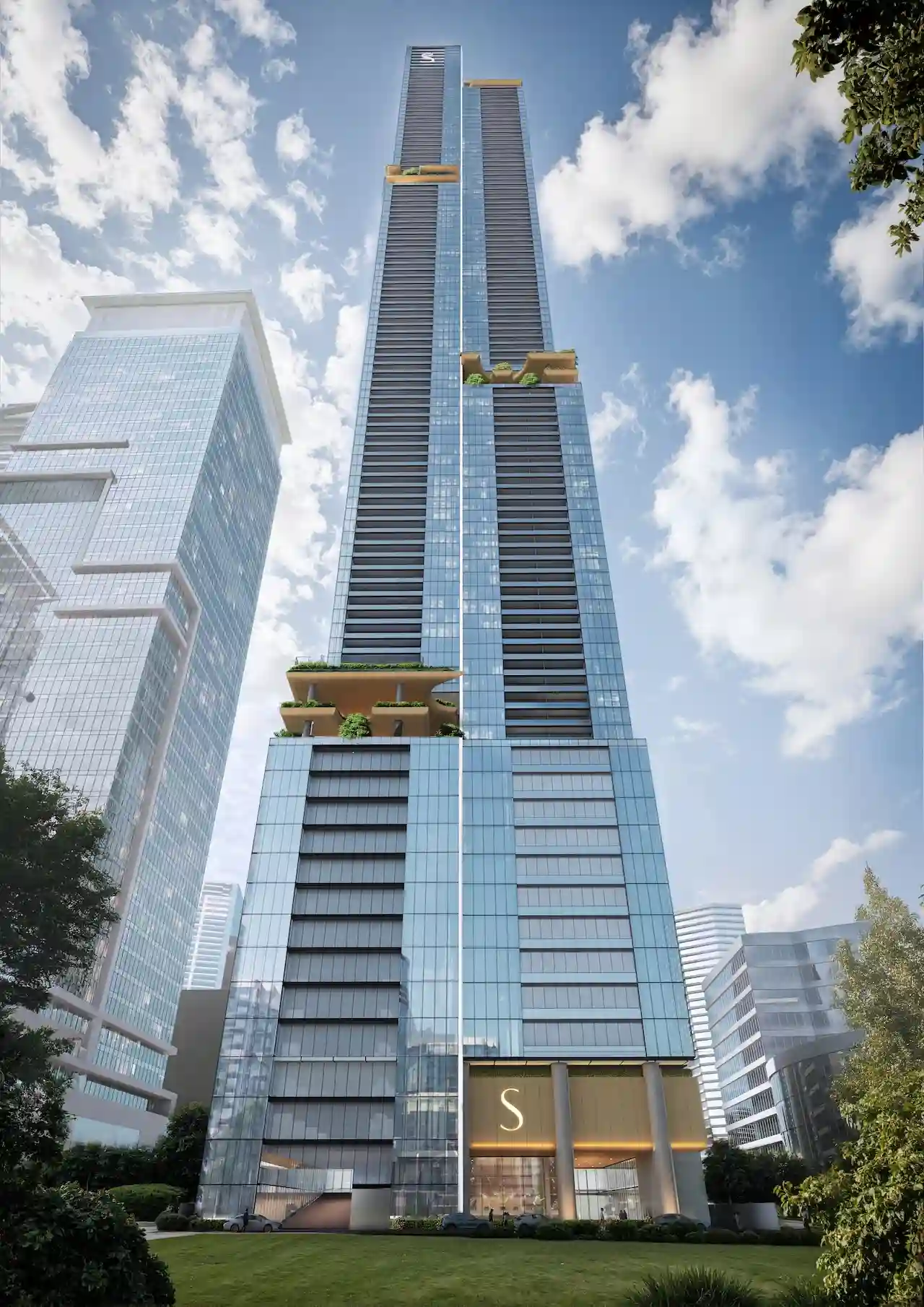 Daytime exterior view of Sobha Sky Park tower on Sheikh Zayed Road showcasing its vertical glass facade and sky terraces, presented by Tohid Fetrat.